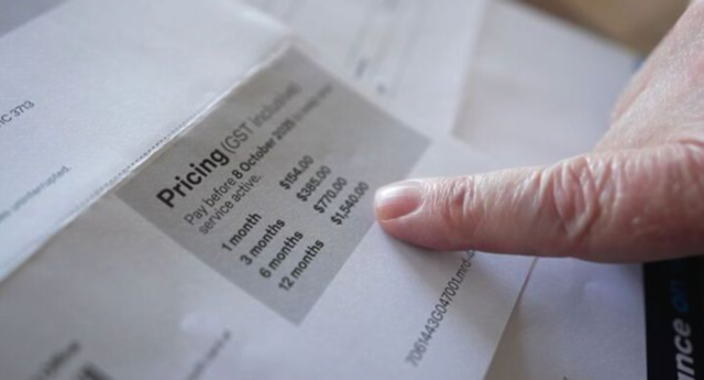 A Melbourne resident points to a postal bill showing an unexpected $1,500 charge caused by an Australia Post system error in October 2025.
